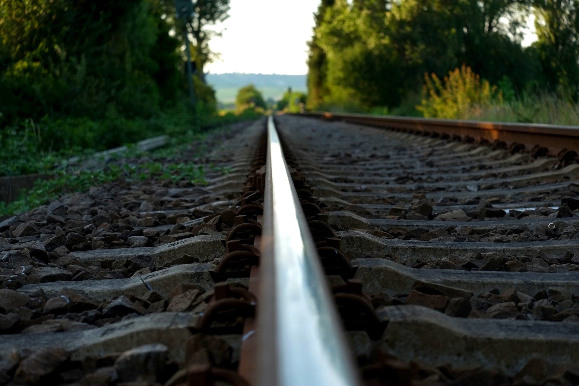 railroad rail in the midst of blurred background of nature